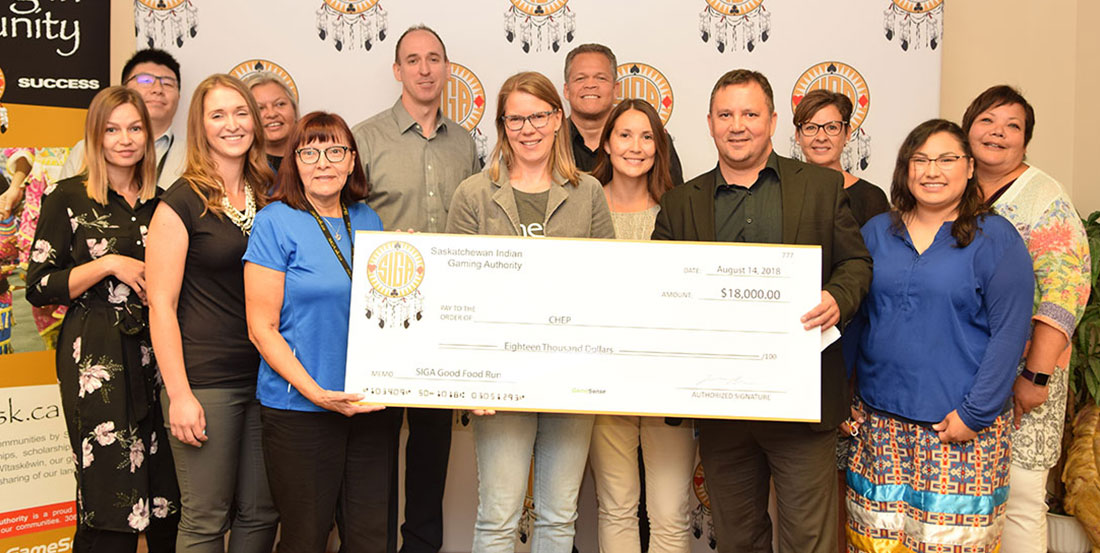 Group of people making community investment cheque presentation