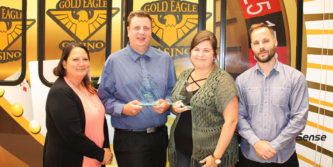 Staff members pose with award