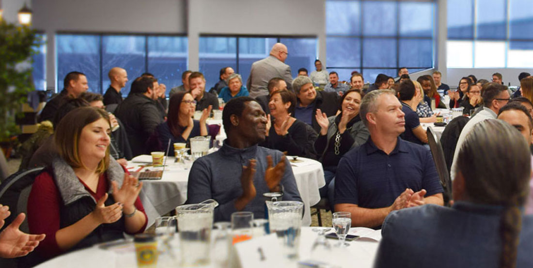 Large group of employees clapping